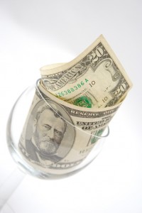 Twenty dollar bills in a wine glass